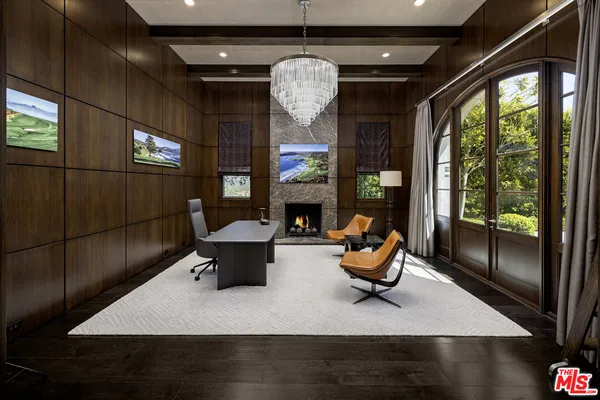 a living room with fireplace furniture and a large window