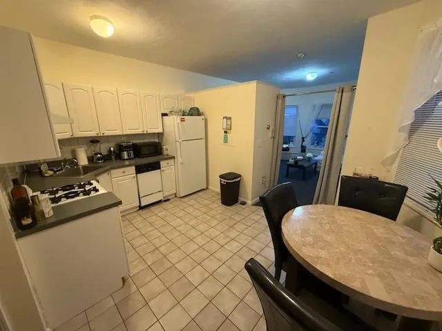 a kitchen with a table and chairs