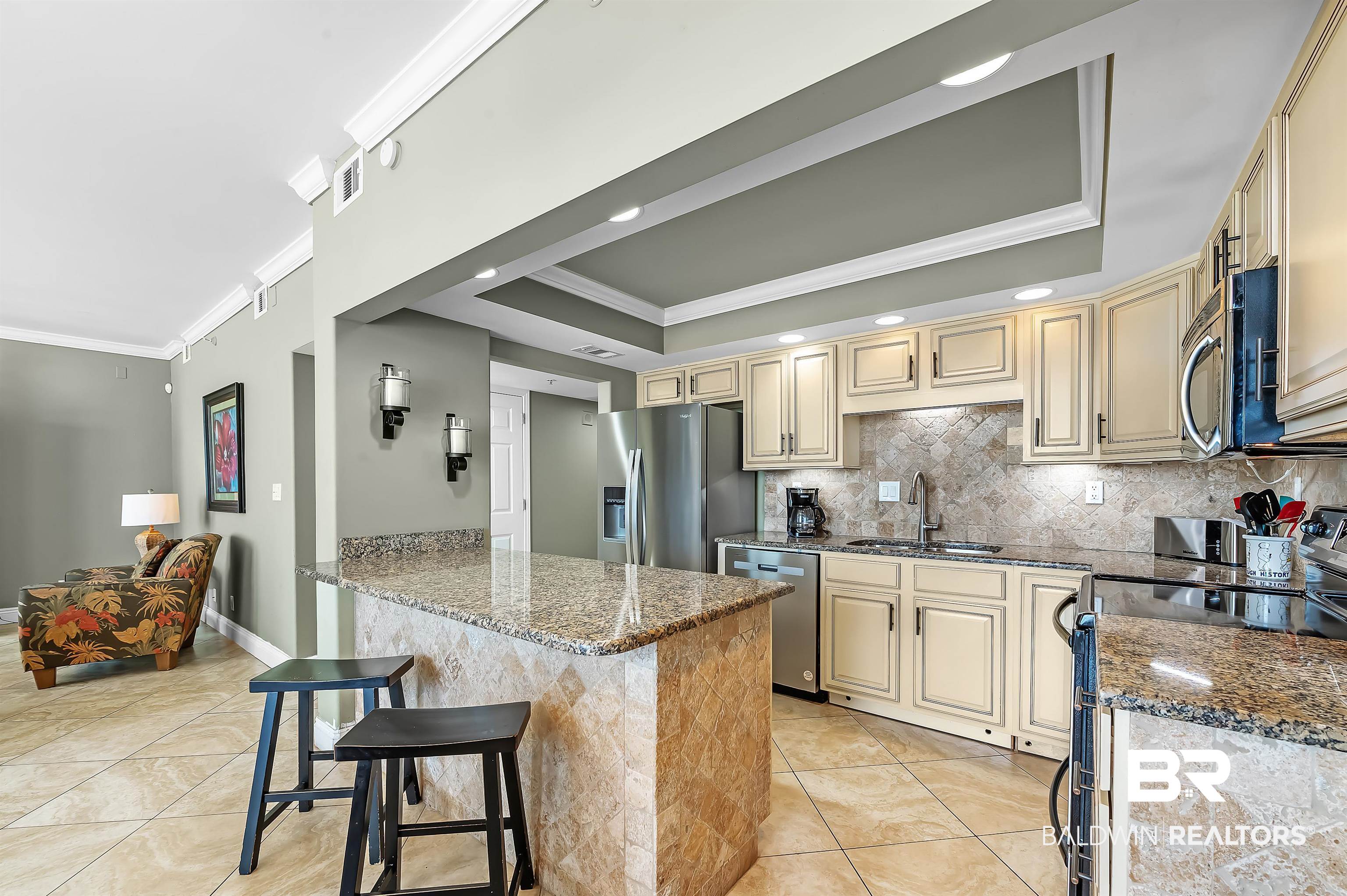 16287 Perdido Key Drive, Unit 105 Pensacola, FL 32507 - Photo 20 of 66 Kitchen featuring light cabinetry, stainless steel appliances, and a tile backsplash