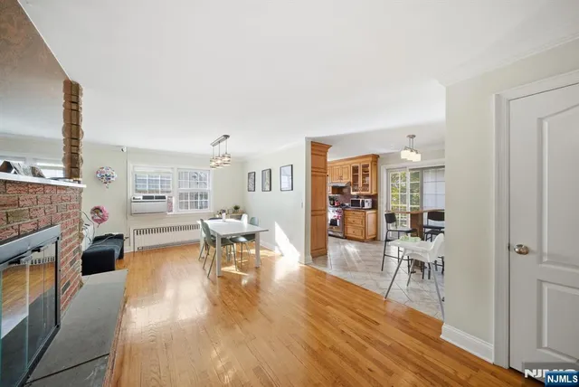 a view of a dining room with furniture and a chandelier
