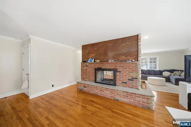 a kitchen with stainless steel appliances granite countertop a stove a sink dishwasher and cabinets with wooden floor