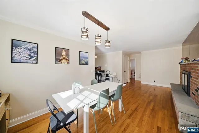 a kitchen with stainless steel appliances granite countertop a stove a sink dishwasher and cabinets with wooden floor