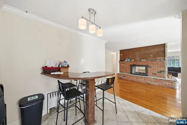 a view of a yard with plants and large trees