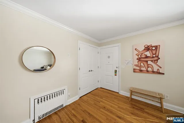 a view of a room with wooden floor and entryway