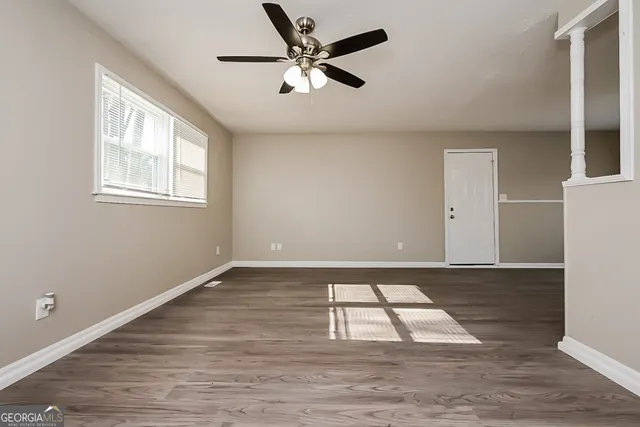 wooden floor in an empty room with a window