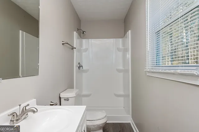 a bathroom with a sink toilet and shower