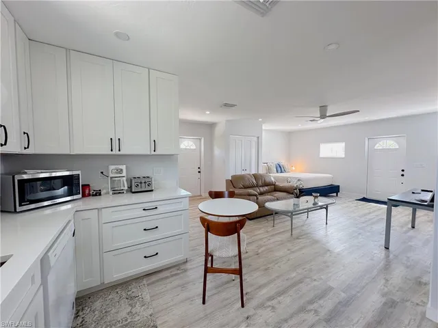 a kitchen with stainless steel appliances a refrigerator sink and cabinets