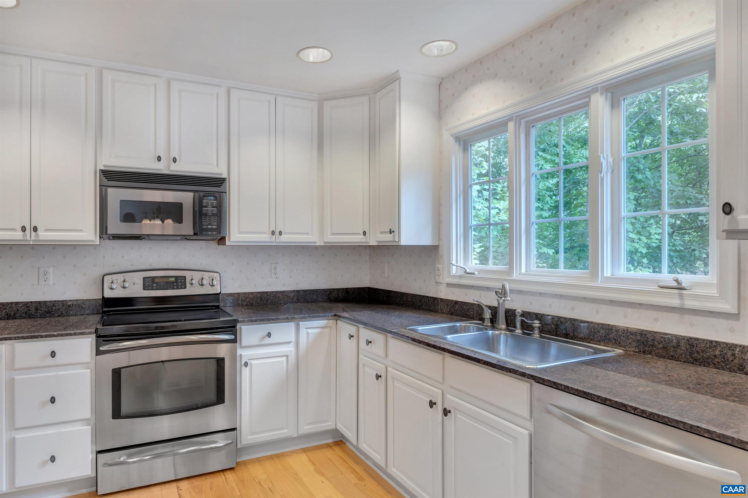 11 Laguna Road Palmyra, VA 22963 - Photo 9 of 29 a kitchen with granite countertop a sink a stove and cabinets