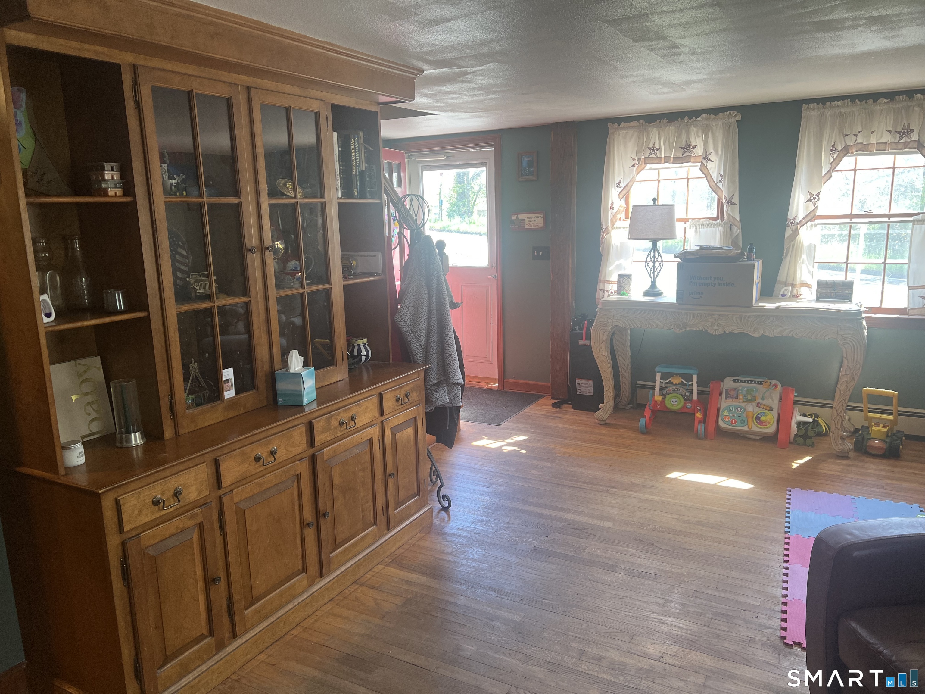 527 Lake Street Manchester, CT 06042 - Photo 8 of 15 a hallway with wooden floors and cabinet