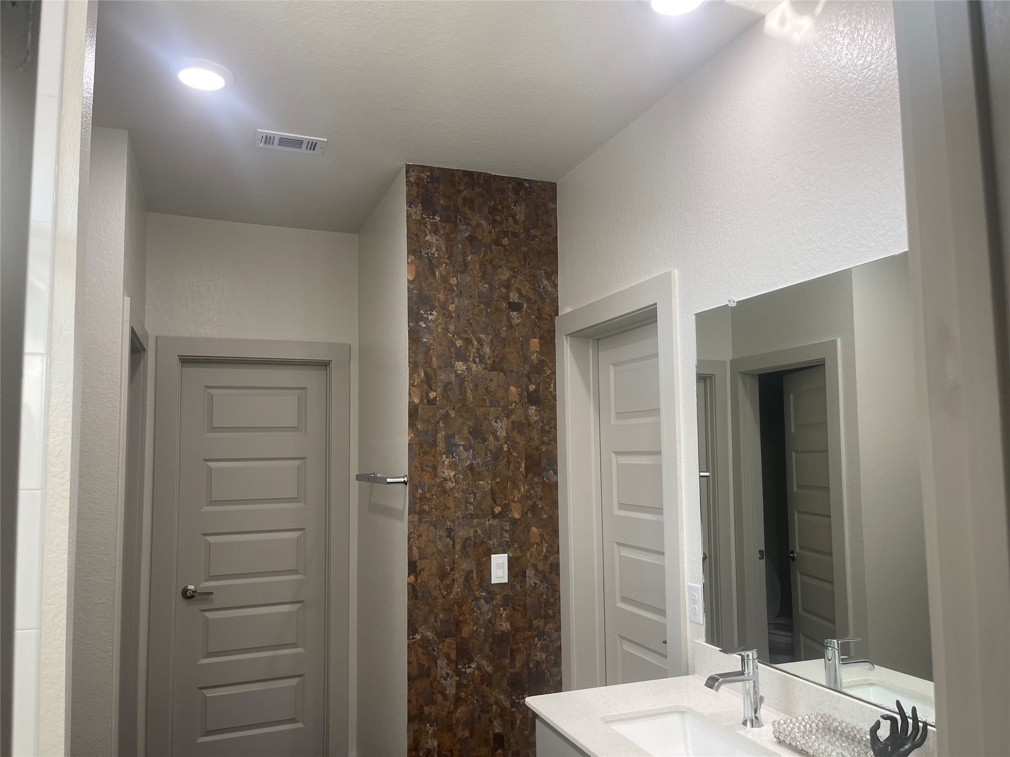 145 Merrick Road Georgetown, TX 78628 - Photo 21 of 32 An accent wall adds rich texture to this modern bathroom space featuring crisp finishes.
