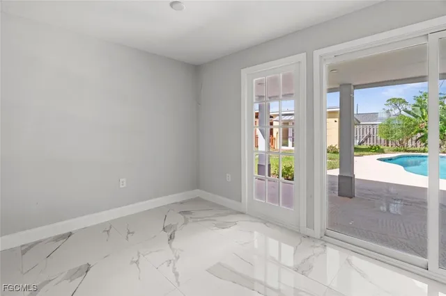 a view of a house with pool and sitting area