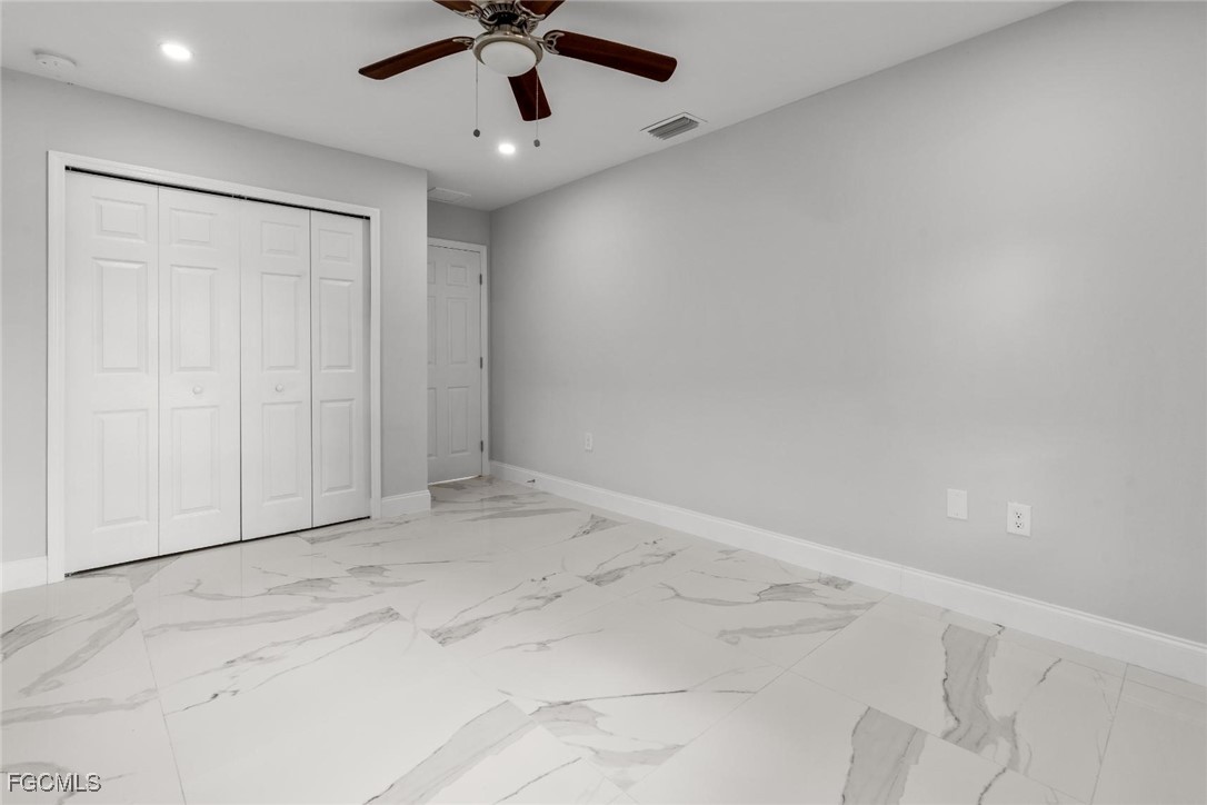 4970 Riverside Drive Estero, FL 33928 - Photo 21 of 35 an empty room with a ceiling fan and a window