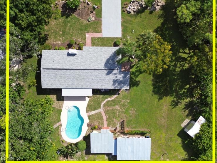 4970 Riverside Drive Estero, FL 33928 - Photo 33 of 35 an aerial view of a house with swimming pool and large trees