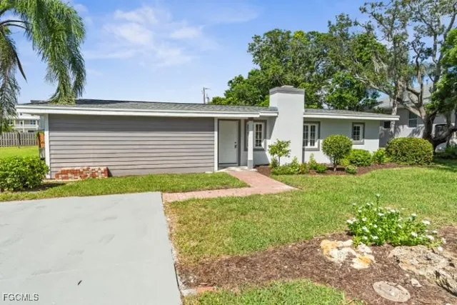 a front view of house with yard and green space