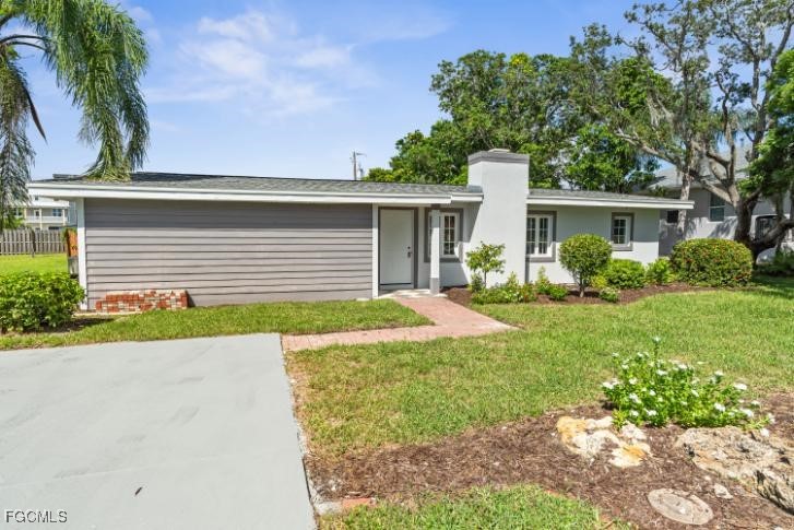 4970 Riverside Drive Estero, FL 33928 - Photo 34 of 35 a front view of a house with garden