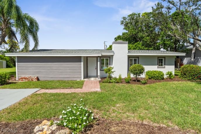 4970 Riverside Drive Estero, FL 33928 - Photo 35 of 35 a front view of house with yard and green space
