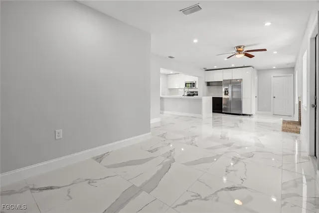 a view of a kitchen with a sink and a refrigerator
