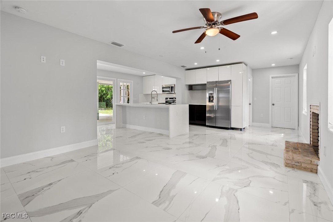 4970 Riverside Drive Estero, FL 33928 - Photo 9 of 35 a view of a kitchen with a sink and a refrigerator
