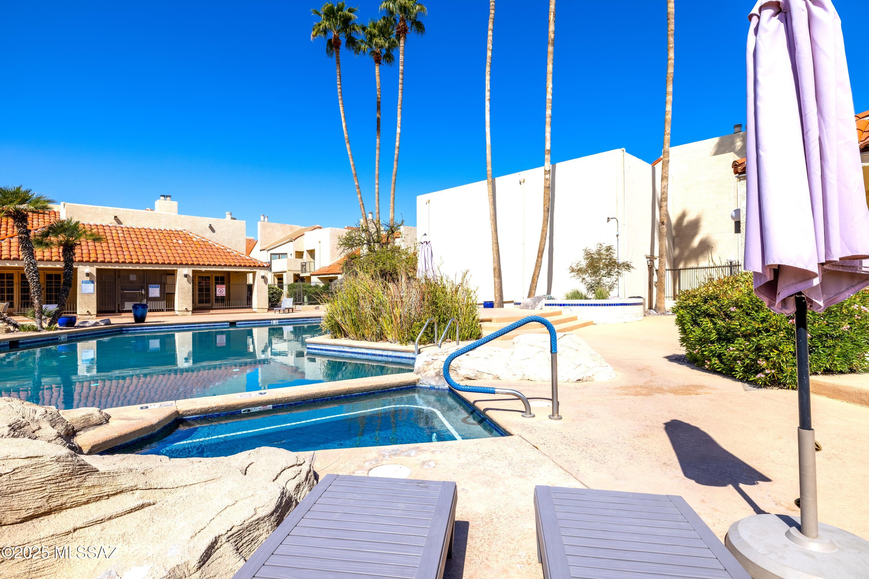 1200 East River Road, Unit G88 Tucson, AZ 85718 - Photo 13 of 13 a view of a house with a swimming pool