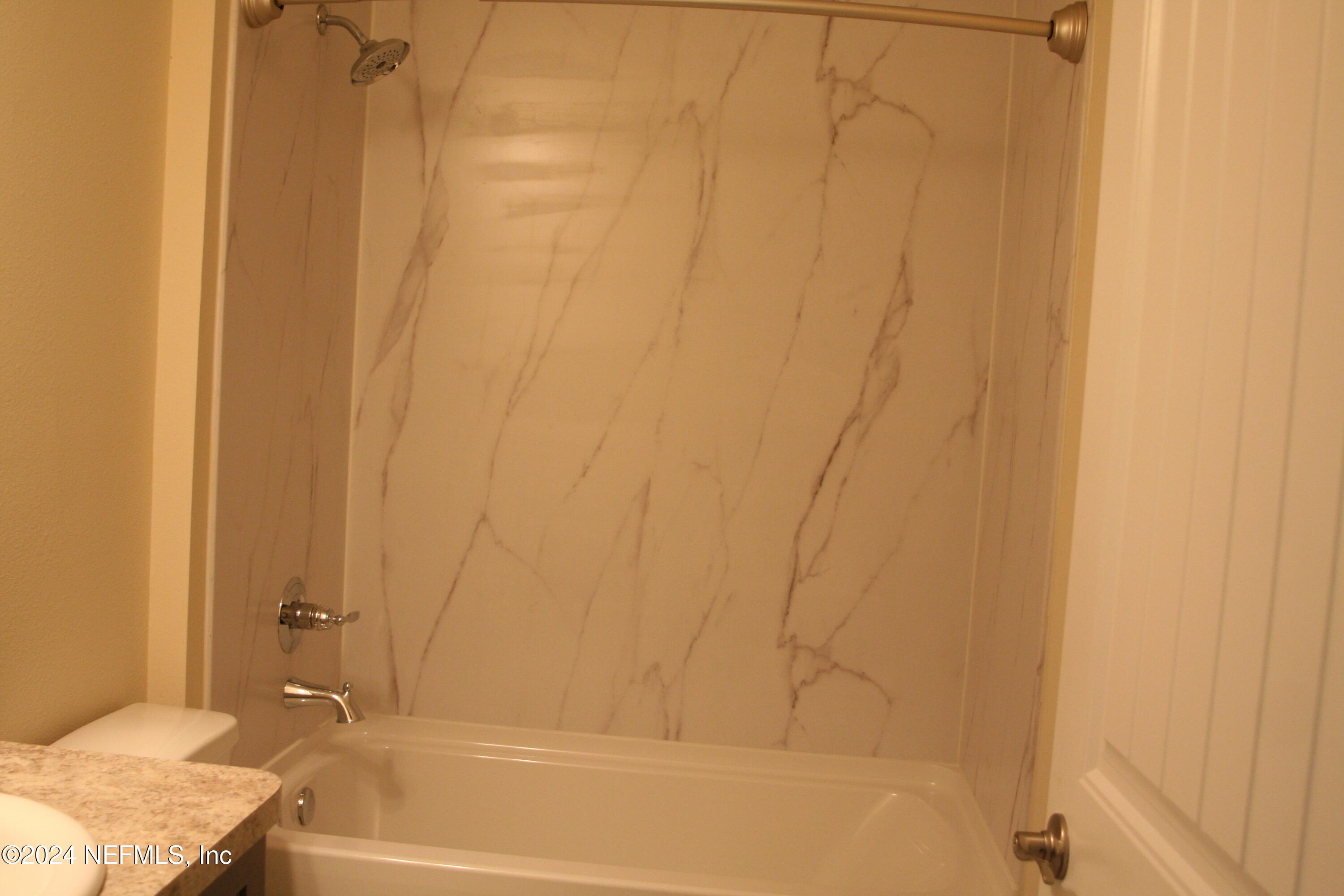 54835 Dornbush Road Callahan, FL 32011 - Photo 8 of 31 a bathroom with a granite countertop sink and a bathtub