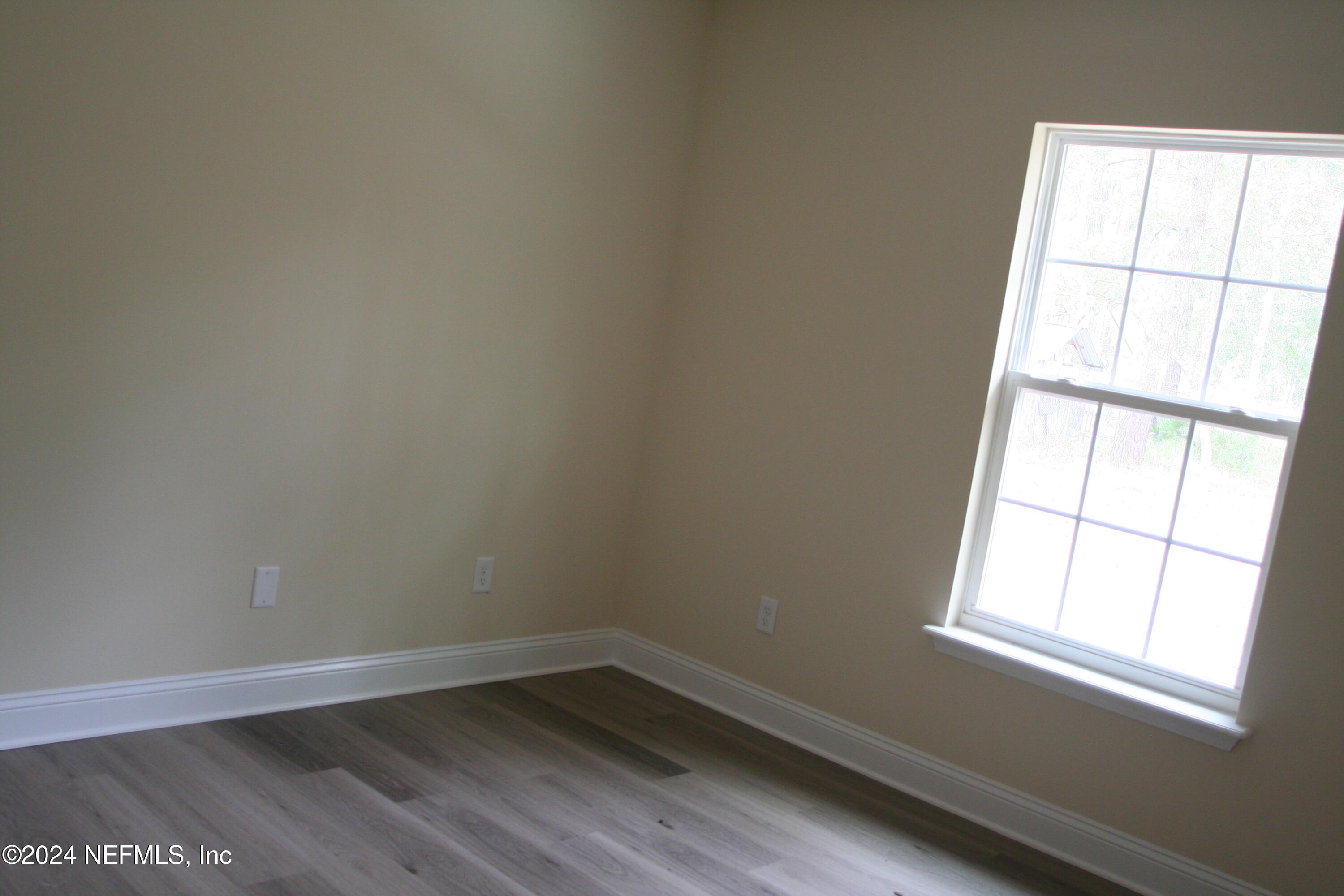 54835 Dornbush Road Callahan, FL 32011 - Photo 10 of 31 an empty room with wooden floor and windows