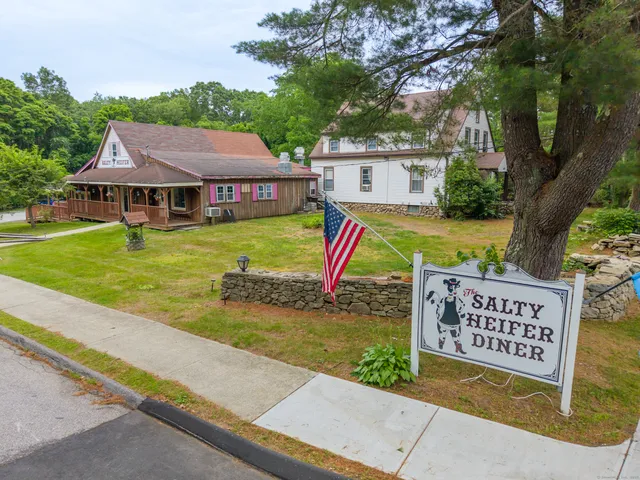 a view of a house with pool and a yard