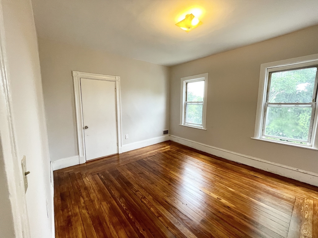 10 Wave Avenue, Unit 2 Boston, MA 02125 - Photo 12 of 15 a view of empty room with window and wooden floor
