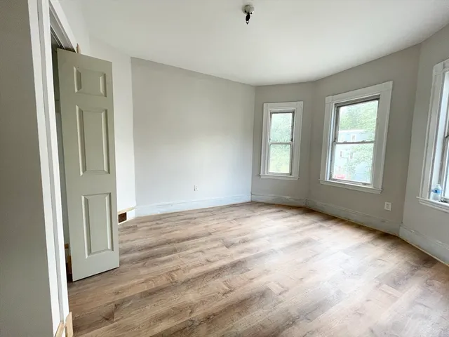 an empty room with windows and closet