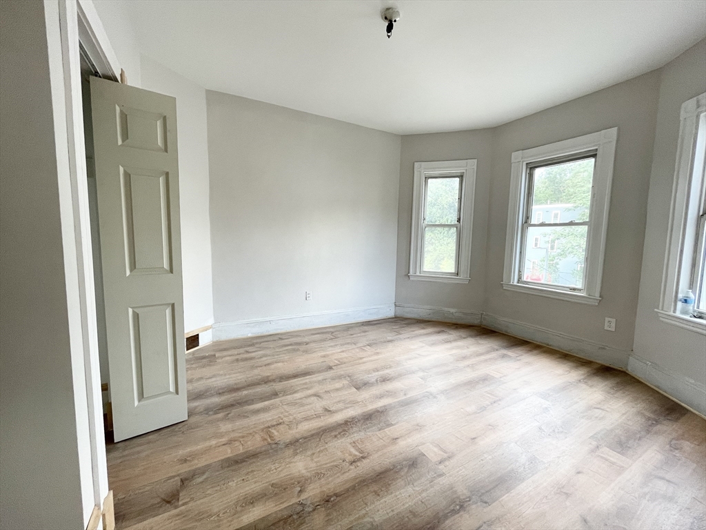 10 Wave Avenue, Unit 2 Boston, MA 02125 - Photo 6 of 15 an empty room with windows and closet