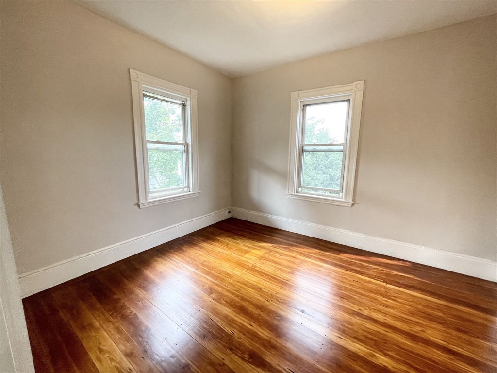 10 Wave Avenue, Unit 2 Boston, MA 02125 - Photo 7 of 15 a view of a room with wooden floor and windows