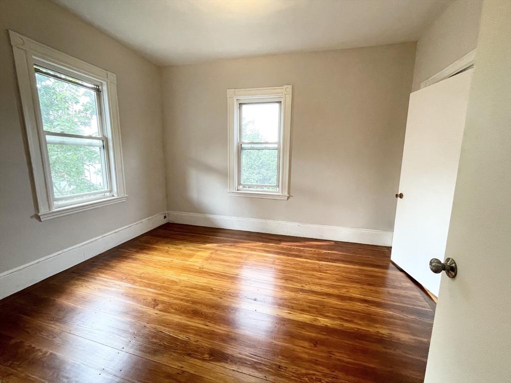 10 Wave Avenue, Unit 2 Boston, MA 02125 - Photo 8 of 15 a view of an empty room with wooden floor and a window