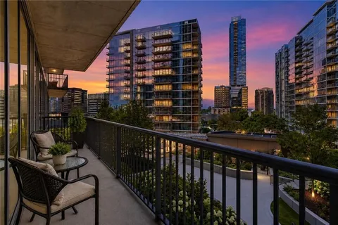 a view of balcony with a potted plant and outdoor seating
