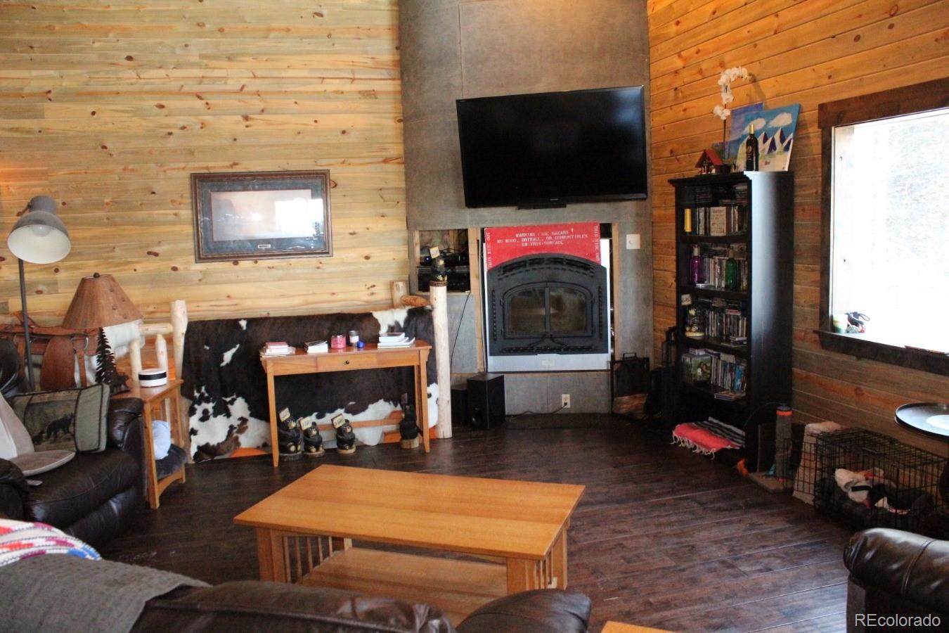 1 Sagamore Trail Black Hawk, CO 80422 - Photo 12 of 34 a living room with furniture a flat screen tv and a fireplace