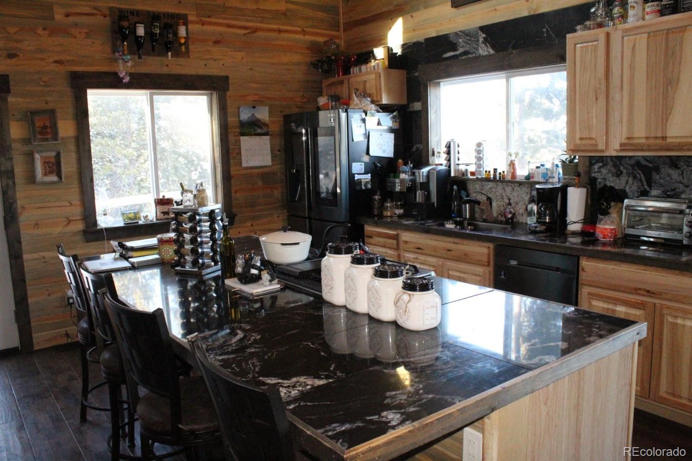 1 Sagamore Trail Black Hawk, CO 80422 - Photo 4 of 34 a kitchen with stainless steel appliances granite countertop a stove a sink and a dining table with granite countertop