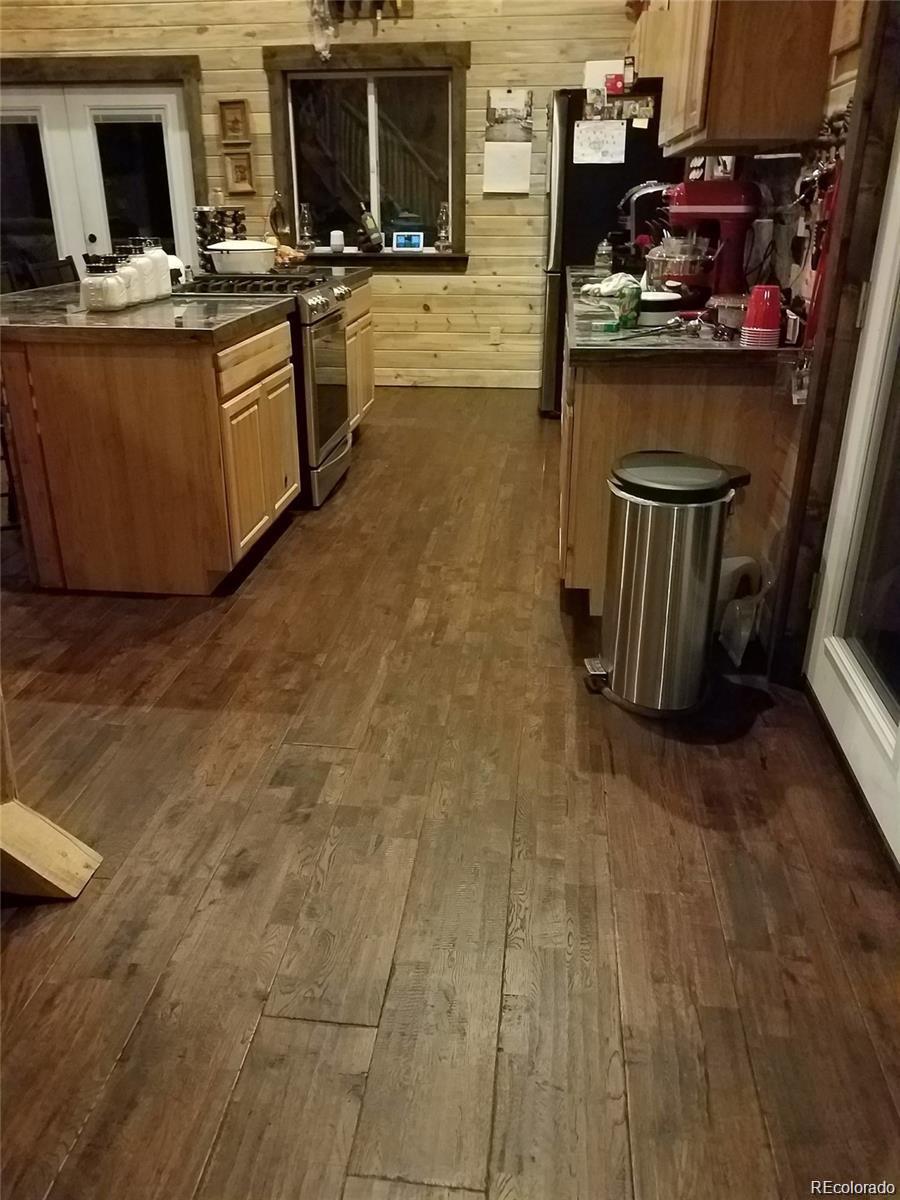 1 Sagamore Trail Black Hawk, CO 80422 - Photo 9 of 34 a kitchen with stainless steel appliances a stove top oven a sink dishwasher and a microwave oven