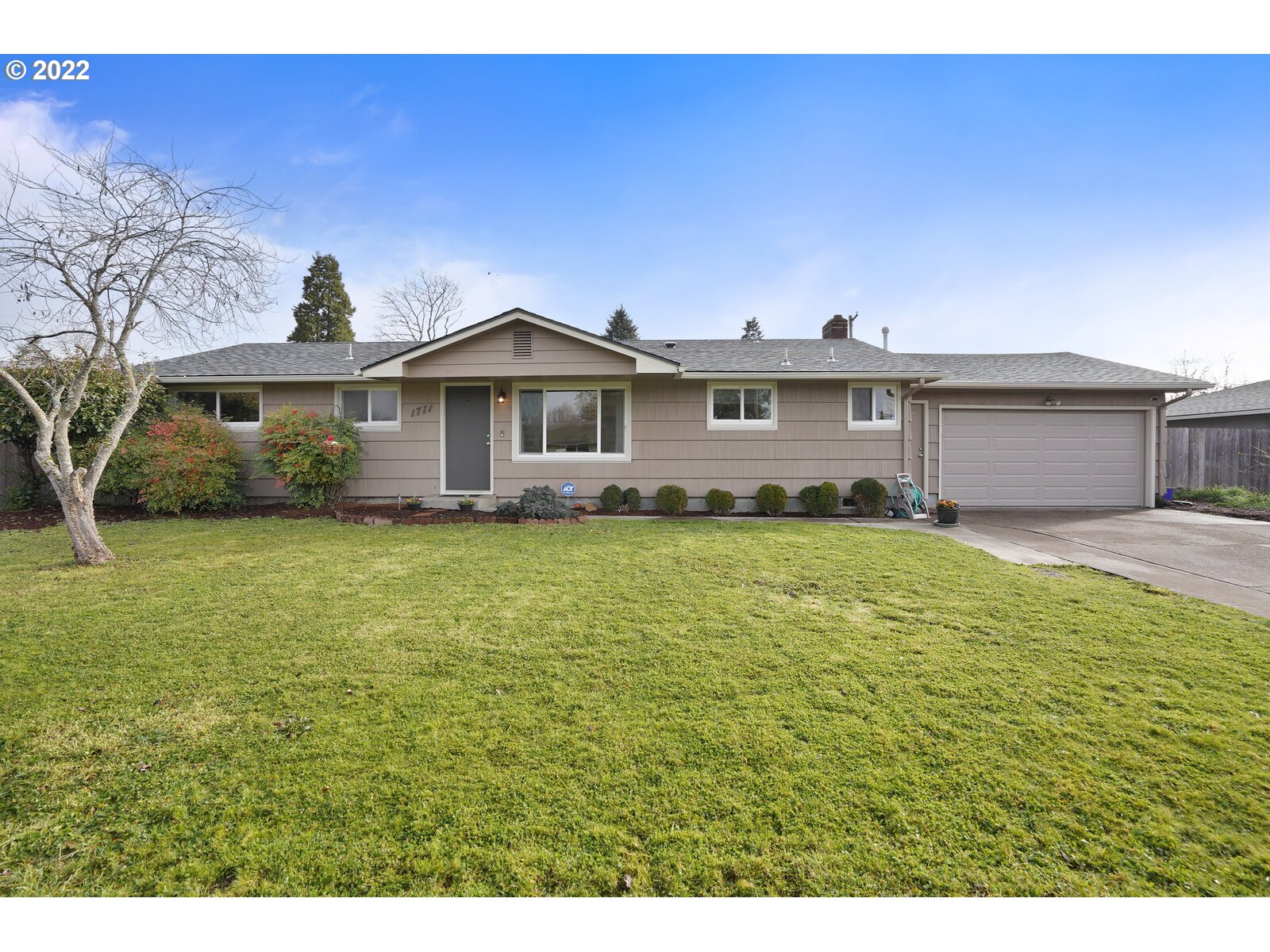 a front view of a house with a garden