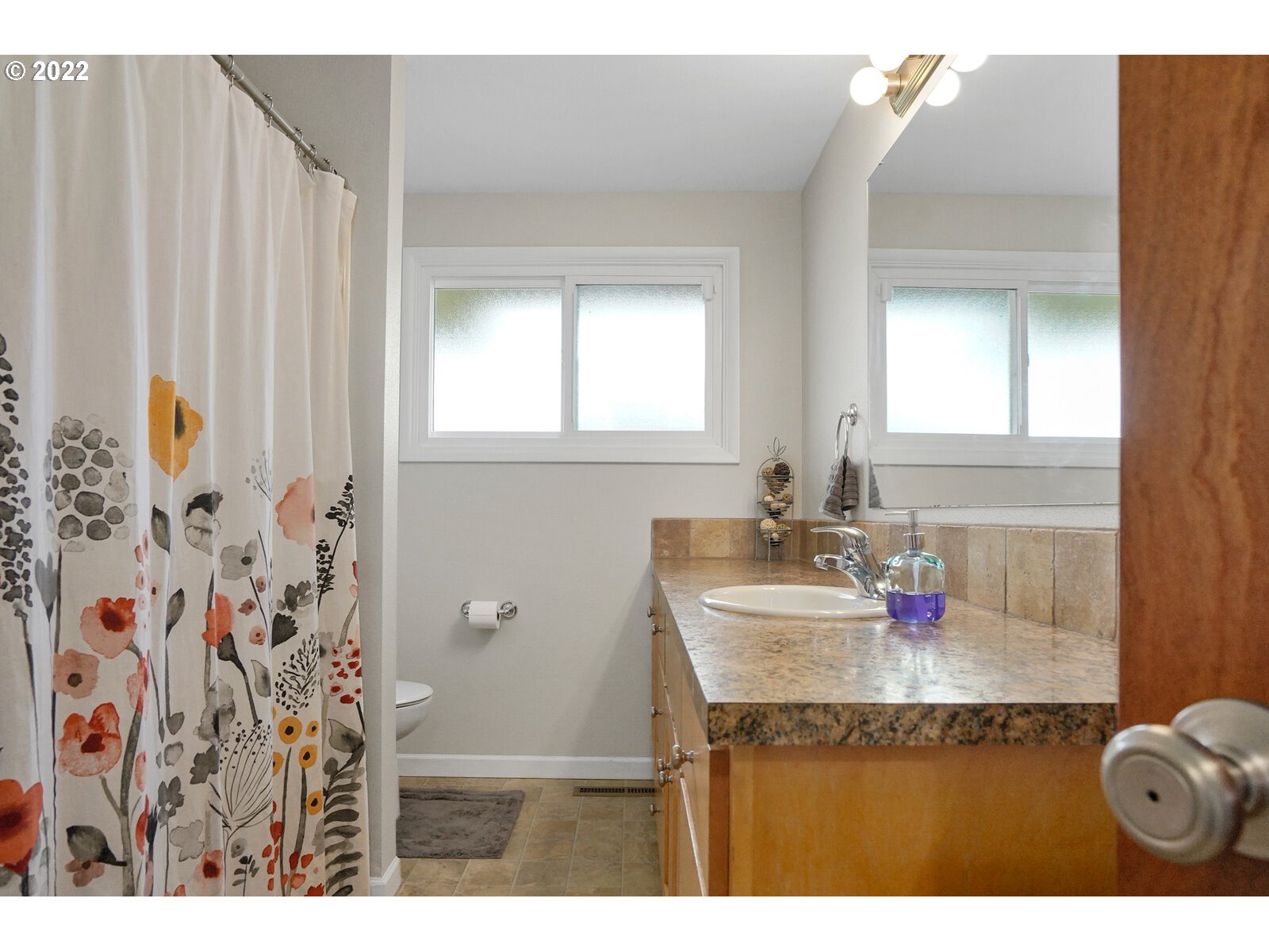 1771 Linwood Street Eugene, OR 97404 - Photo 6 of 22 a bathroom with a granite countertop sink and a mirror