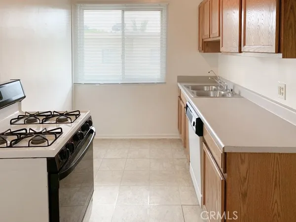 a kitchen that has a sink and a stove