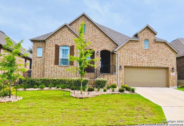 9022 Pond Gate Boerne, TX 78015 - Photo 1 of 1 a front view of a house with a yard and garage