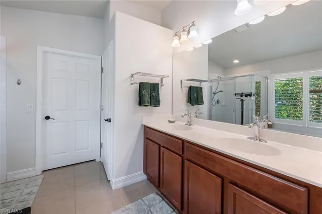 a bathroom with a sink double vanity and a mirror