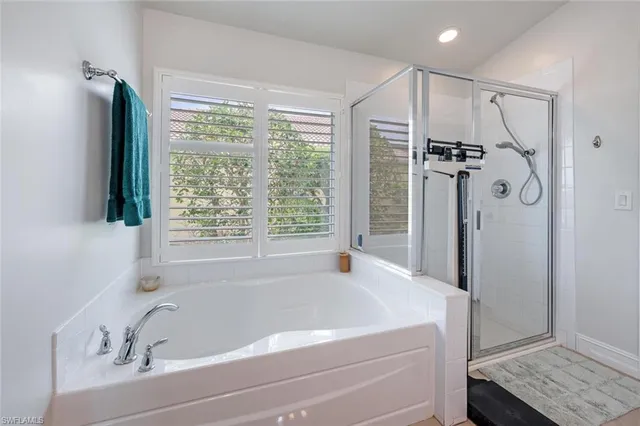 a bathroom with a bathtub and a shower