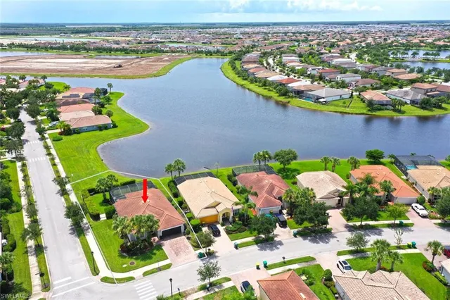 an aerial view of swimming pool patio and lake view