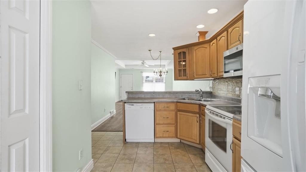 604 Elm Way Coraopolis, PA 15108 - Photo 16 of 30 a kitchen with stainless steel appliances granite countertop a sink and a stove top oven