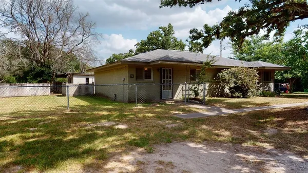 a view of a wooden house with a yard