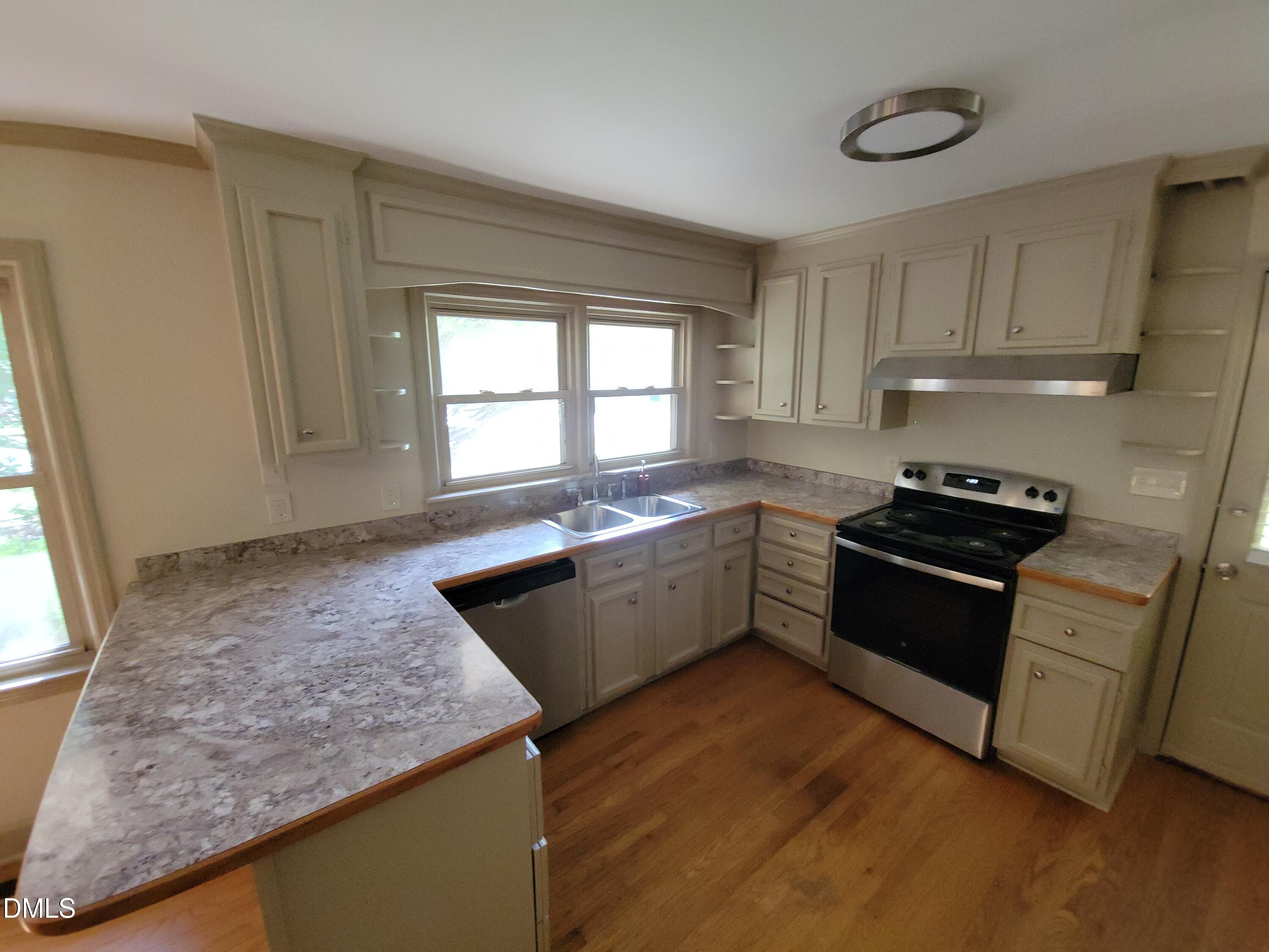 7000 Holly Springs Road Raleigh, NC 27606 - Photo 12 of 24 a kitchen with granite countertop a sink a counter top space and appliances