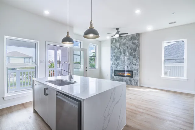 a large white kitchen with a large window