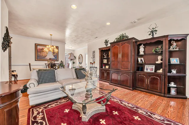 a living room with furniture a flat screen tv and rug