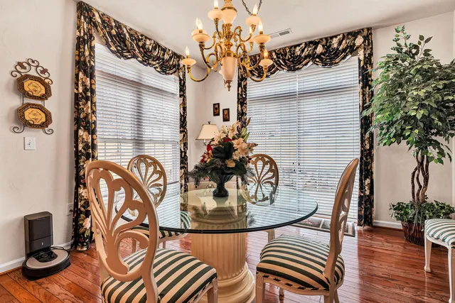 a dining room with furniture and wooden floor