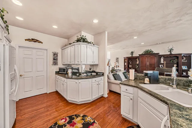 a kitchen with stainless steel appliances kitchen island granite countertop a stove and a sink