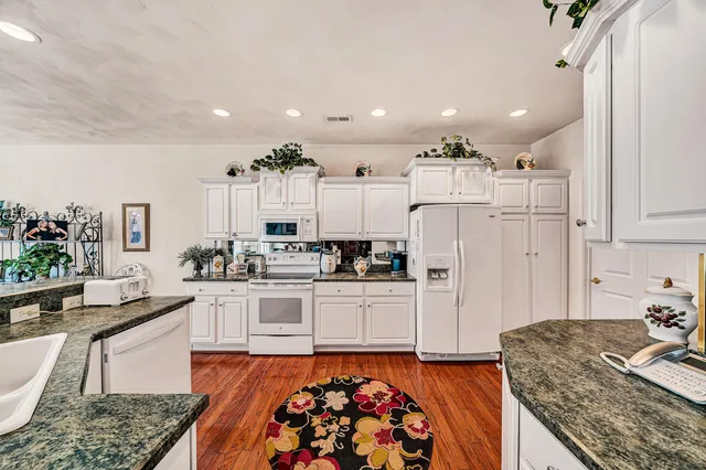 a large white kitchen with lots of counter space